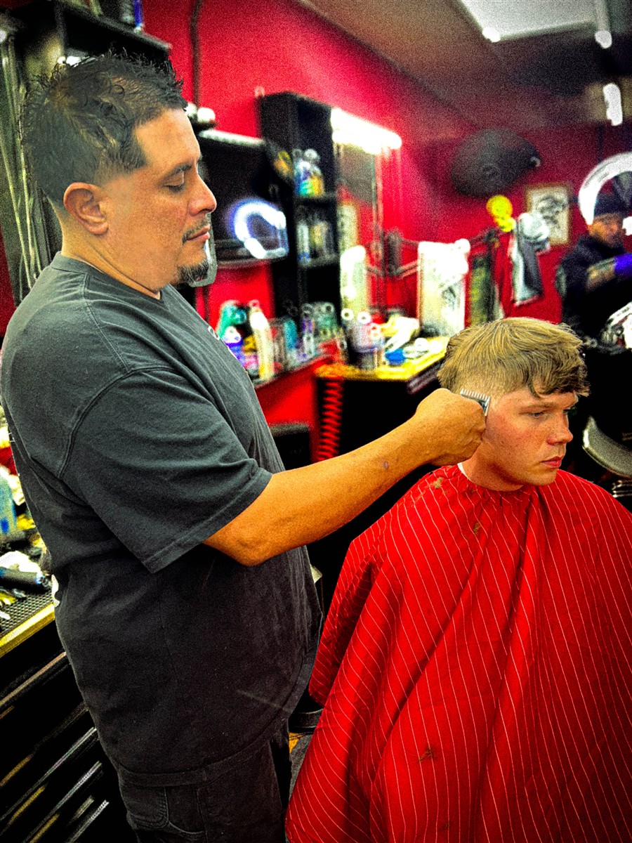 Mario cutting a client's hair