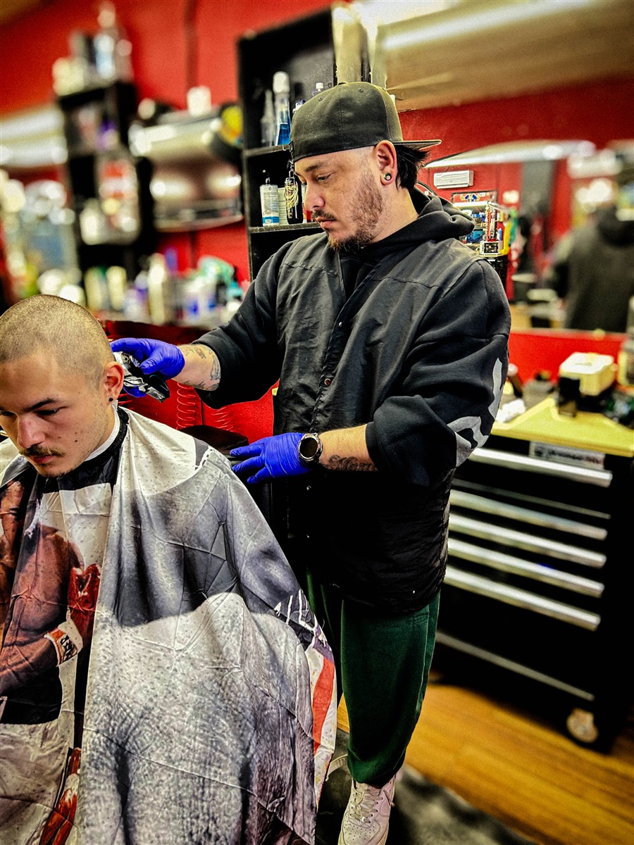 Miguel cutting a client's hair